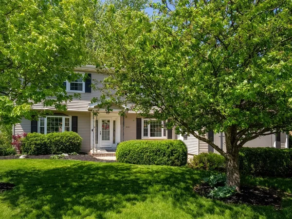 a front view of a house with a yard