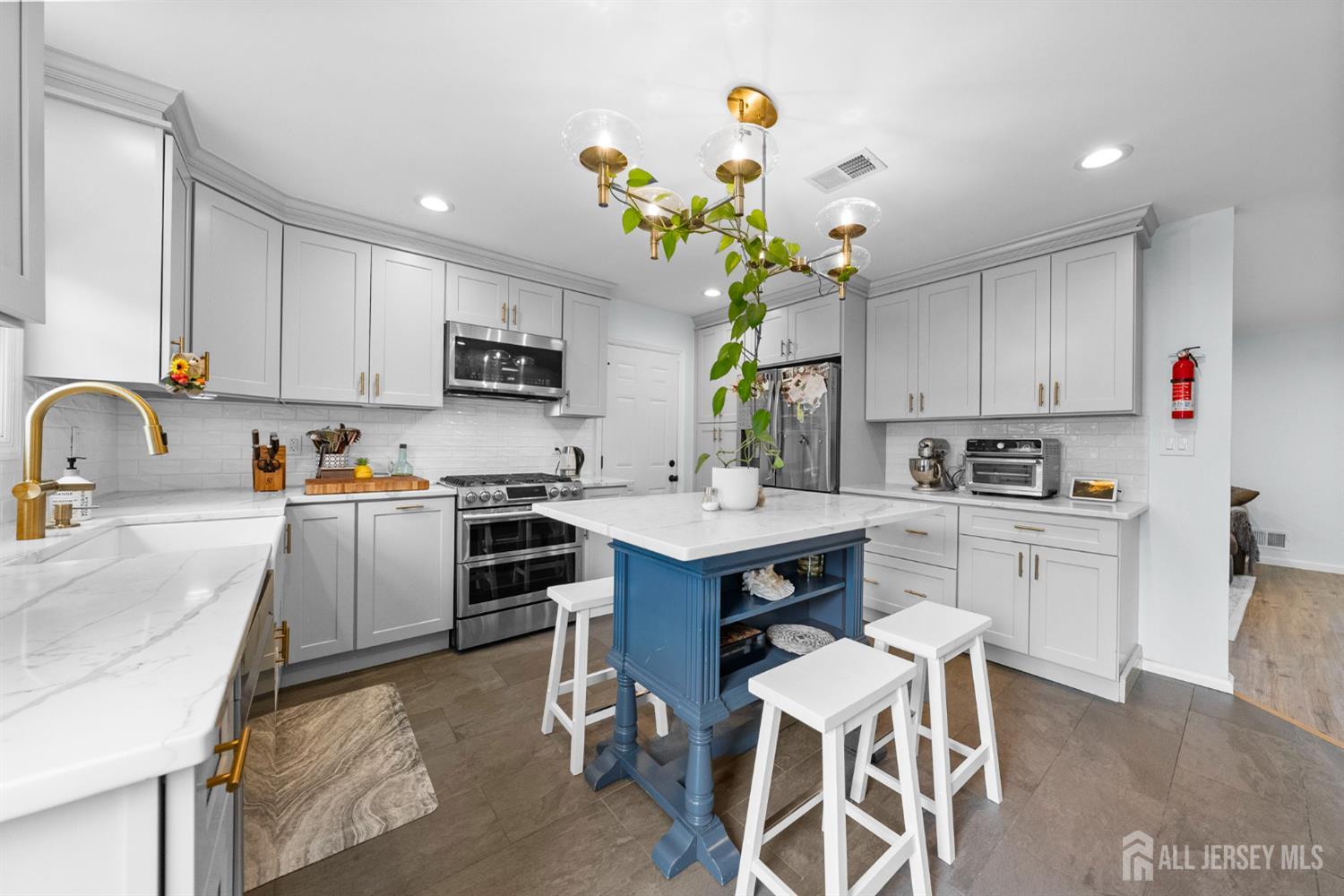 243 Alpine Way Old Bridge, NJ 08879 - Photo 13 of 45 a kitchen with kitchen island granite countertop stainless steel appliances cabinets a sink and a counter top space