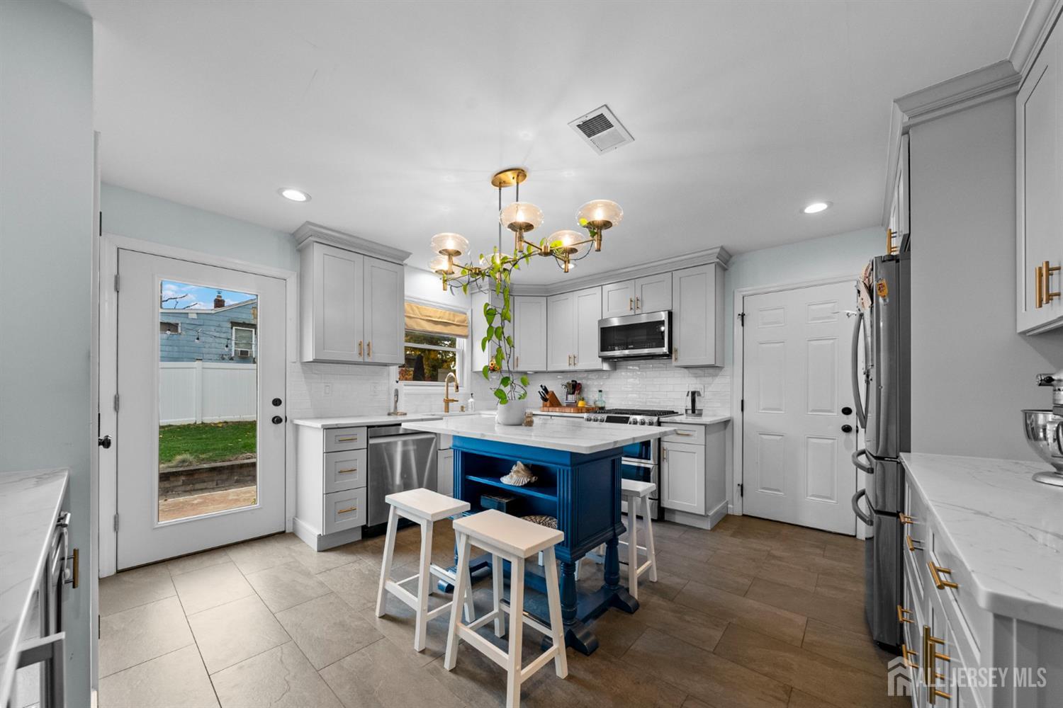 243 Alpine Way Old Bridge, NJ 08879 - Photo 14 of 45 a view of kitchen with kitchen island stainless steel appliances microwave stove refrigerator dining table and chairs