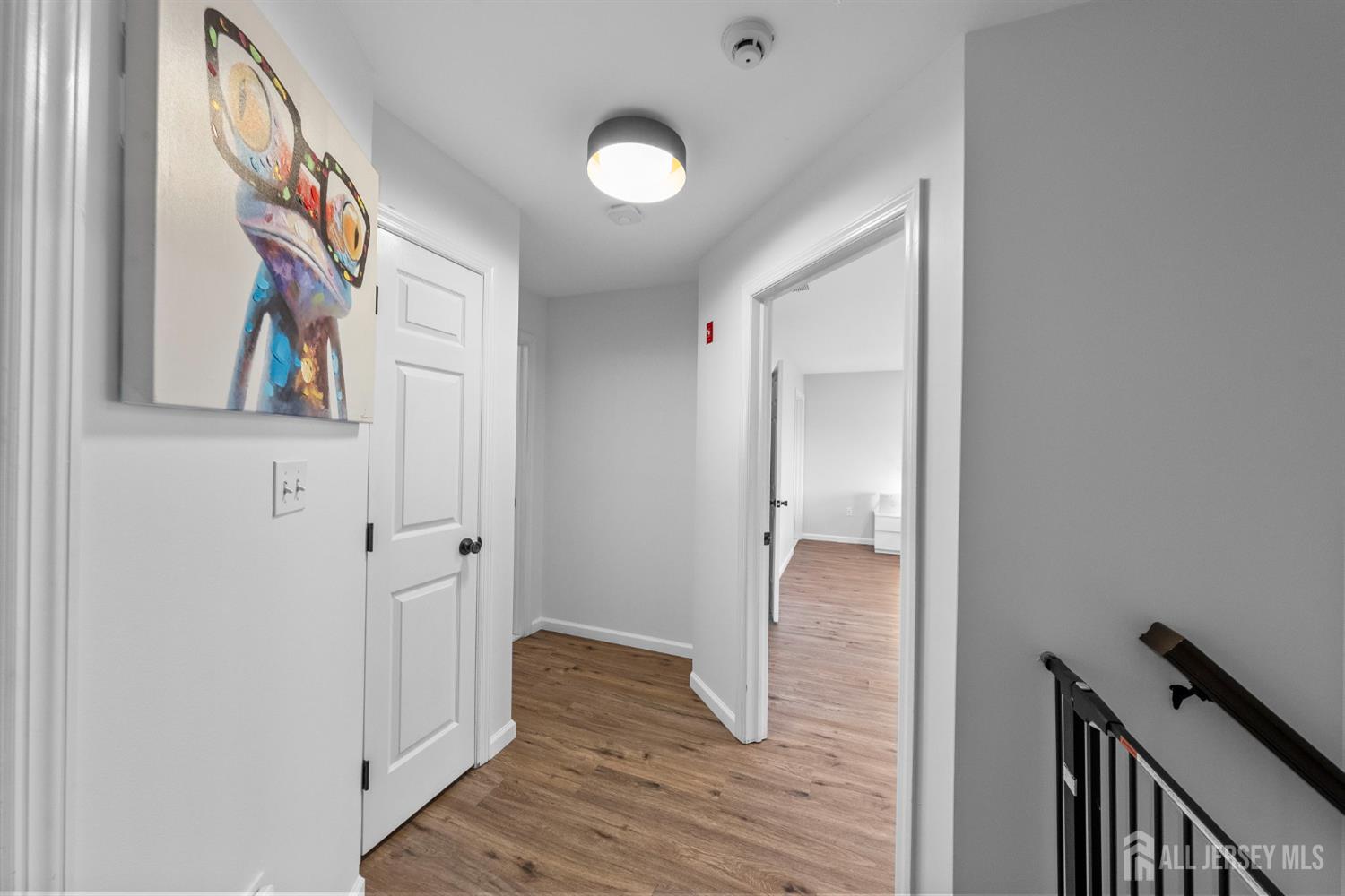 243 Alpine Way Old Bridge, NJ 08879 - Photo 23 of 45 a view of a hallway with wooden floor and staircase