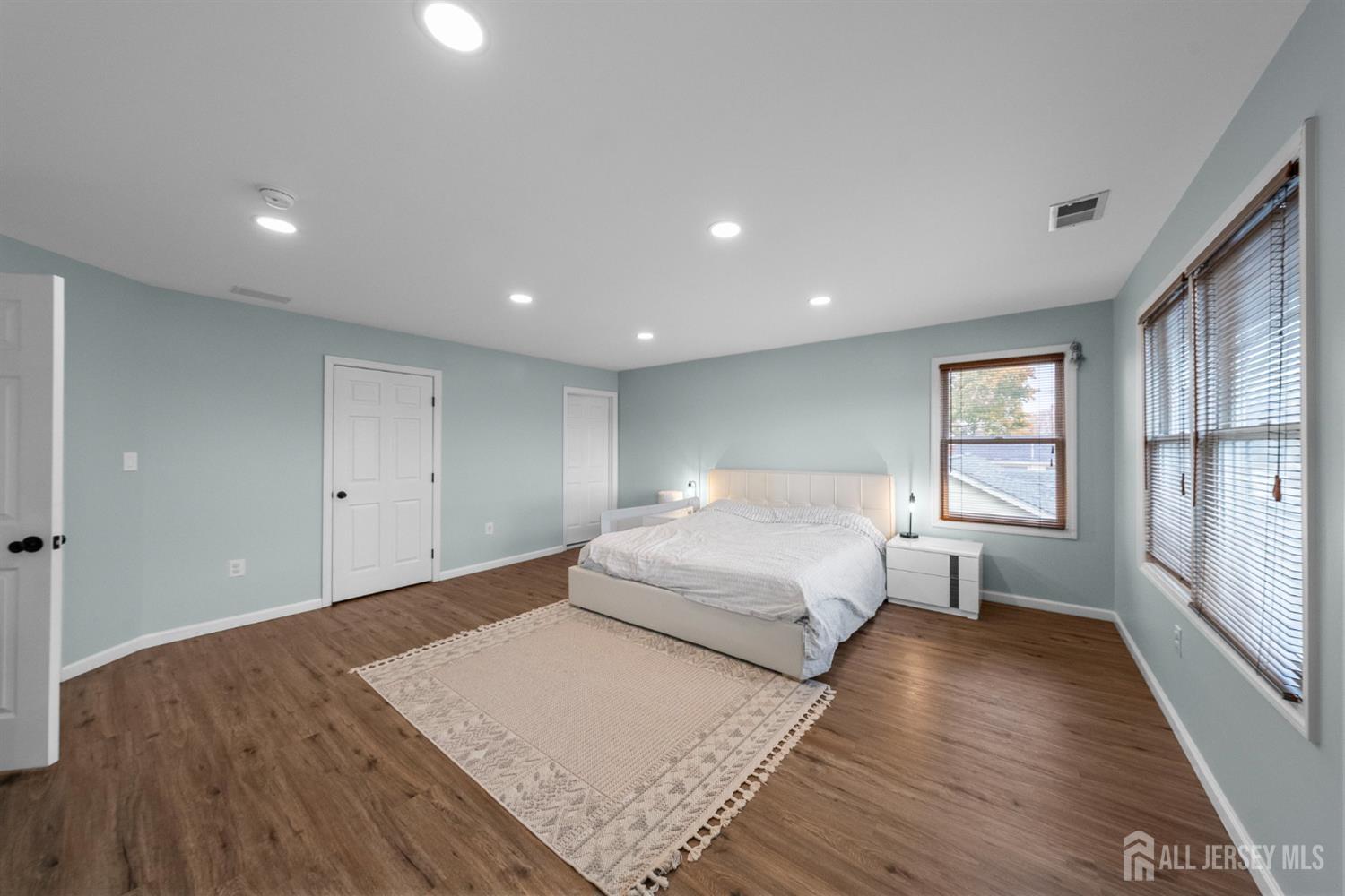 243 Alpine Way Old Bridge, NJ 08879 - Photo 24 of 45 a spacious bedroom with a bed and wooden floor