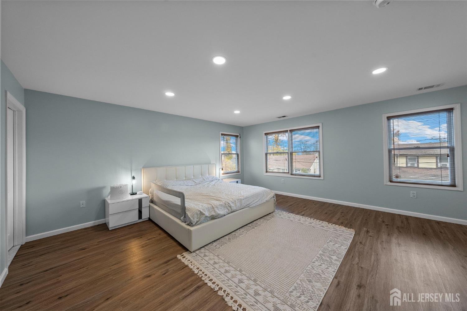 243 Alpine Way Old Bridge, NJ 08879 - Photo 25 of 45 a spacious bedroom with a bed and wooden floor