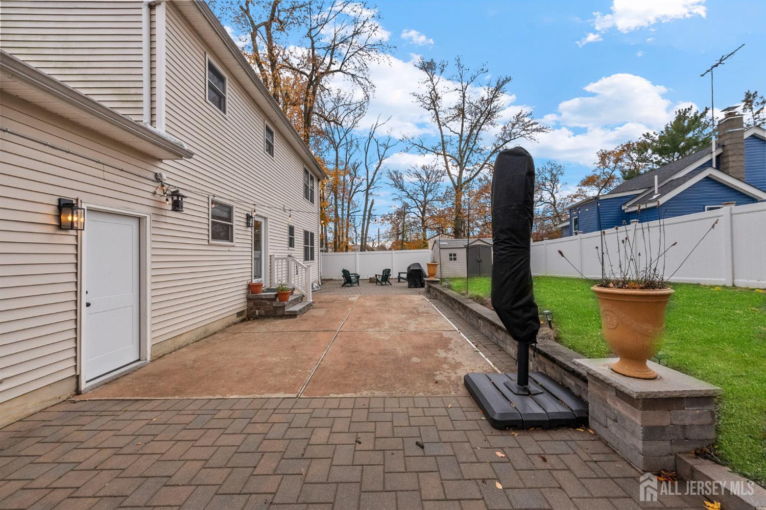 243 Alpine Way Old Bridge, NJ 08879 - Photo 35 of 45 a view of a backyard with chairs and a fire pit