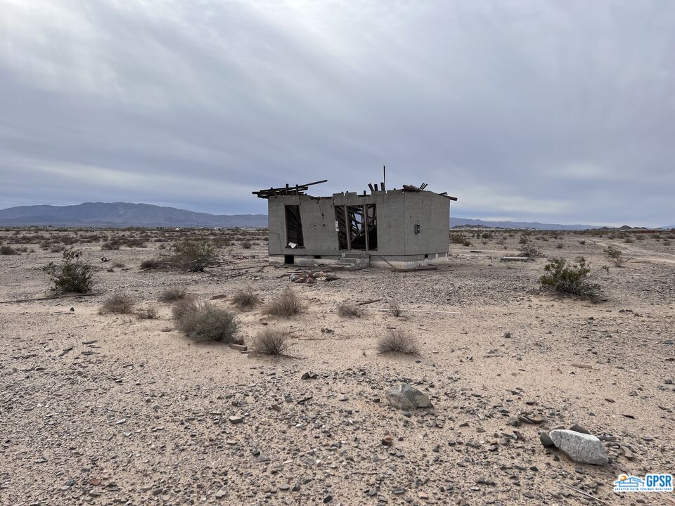 0 Shelton Road Twentynine Palms, CA 92277 - Photo 6 of 7 a view of a dry yard with wooden fence