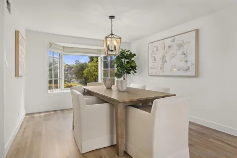 a view of a dining room with furniture and chandelier