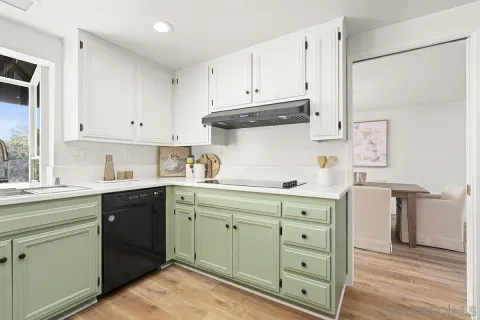 a kitchen with cabinets a refrigerator and a stove