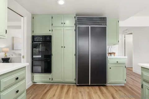 a kitchen with cabinets and window