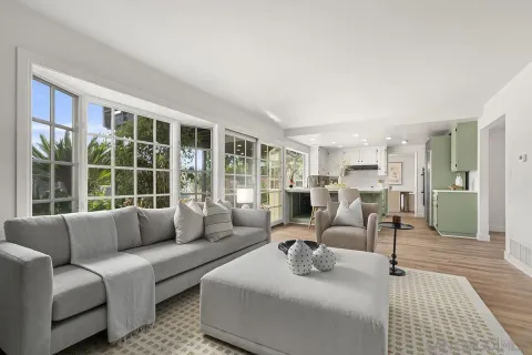 a living room with furniture a clock and a fireplace