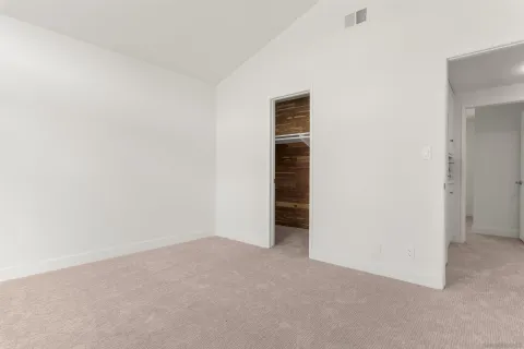 a view of a patio with couches table and chairs under an umbrella with a roof deck