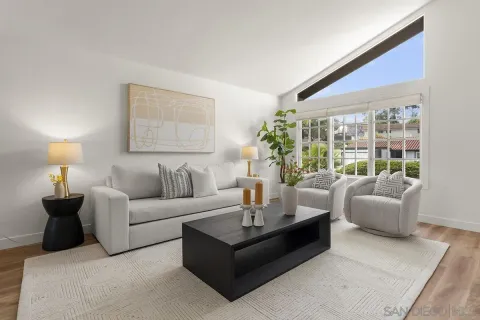 a living room with furniture and painting on the wall