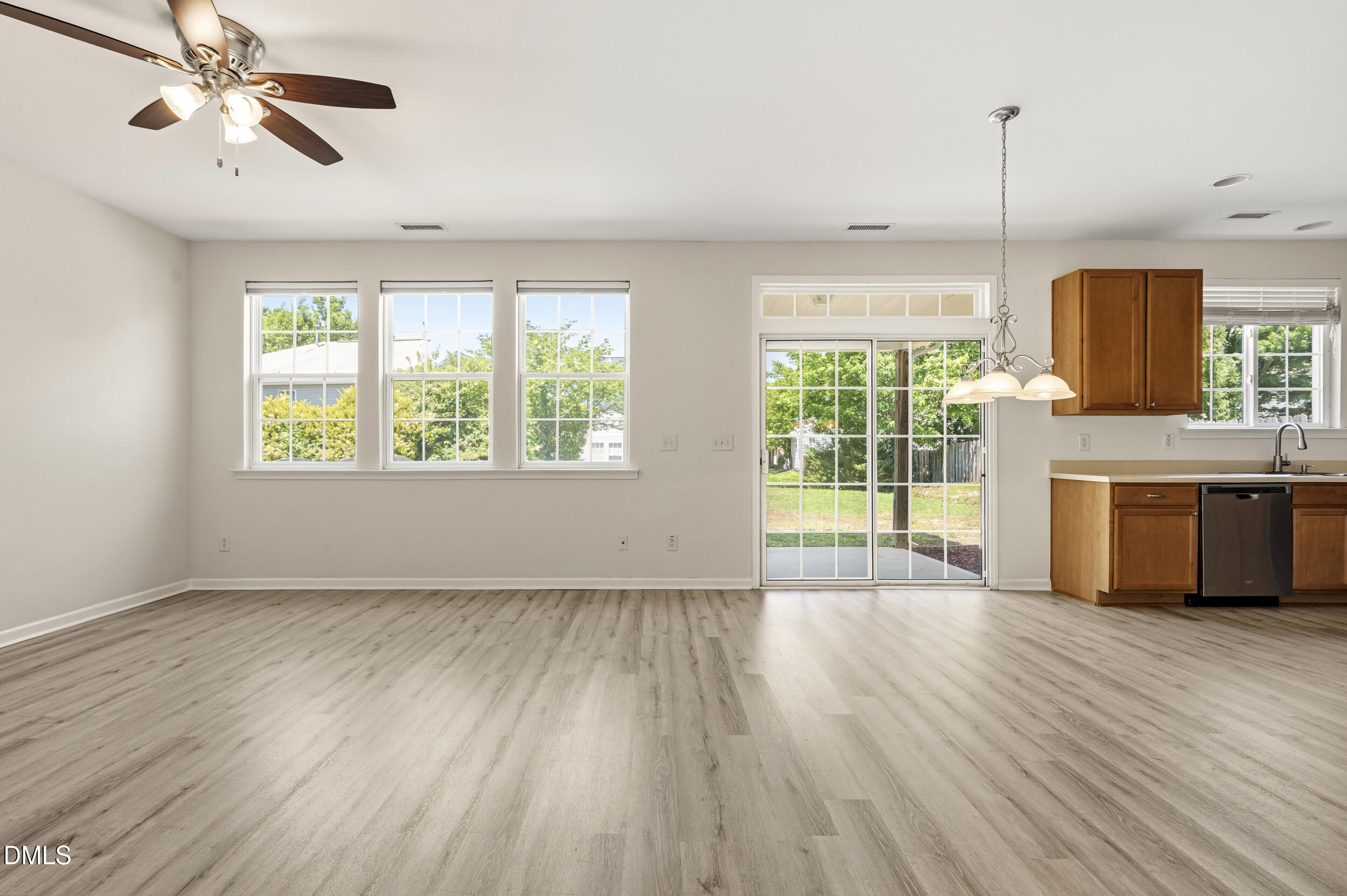 112 Ryder Cup Circle Raleigh, NC 27603 - Photo 4 of 45 a view of a kitchen with wooden floor and a window