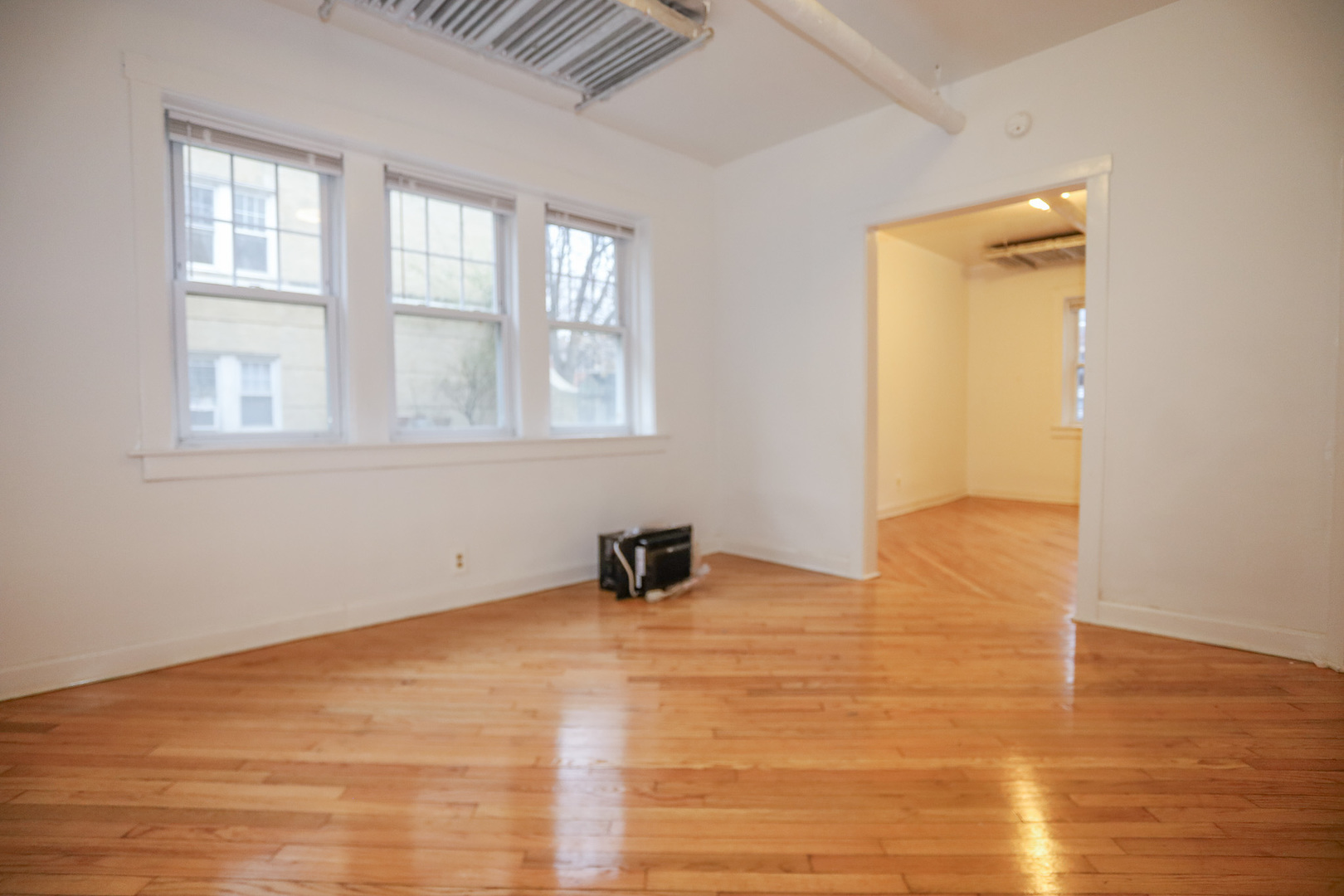 2453 West Gunnison Street, Unit G Chicago, IL 60625 - Photo 2 of 9 a room with window and a wooden floor