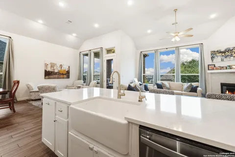 a large white kitchen with a large window