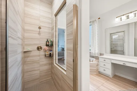 a bathroom with a shower and a sink