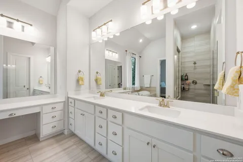 a bathroom with a double vanity sink mirror and double