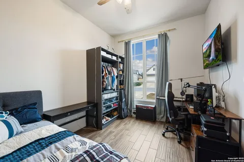 a bedroom with furniture and a flat screen tv