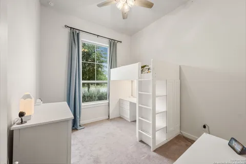 a room with a desk and chandelier