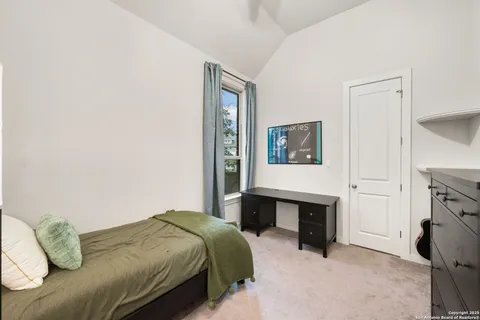 a bedroom with a bed and a table in it