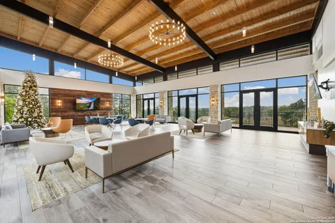 a living room with fireplace furniture and a large window