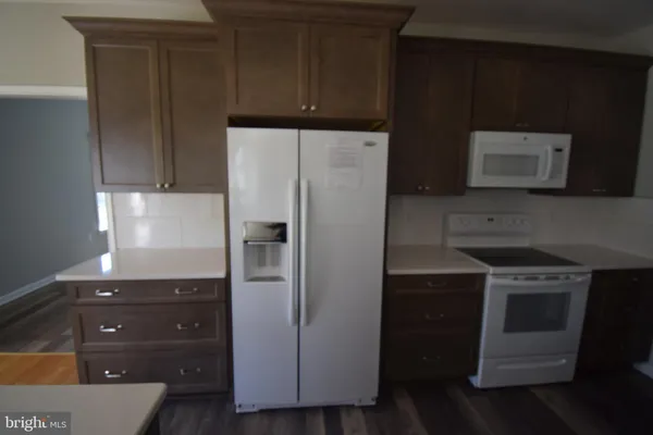 a kitchen with a refrigerator stove and microwave