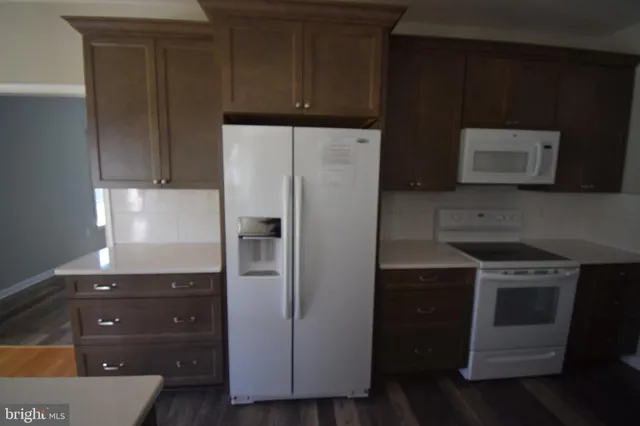 a kitchen with a refrigerator stove and microwave