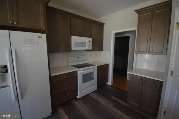 a kitchen with a refrigerator stove and microwave