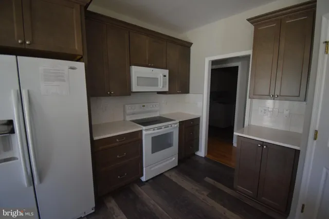 a kitchen with a refrigerator stove and microwave