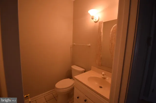a bathroom with a granite countertop toilet and sink