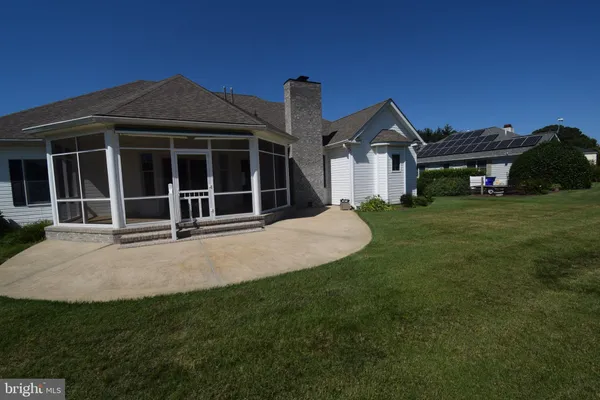 a front view of a house with a garden and yard