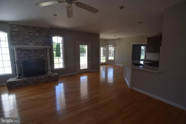 a view of hallway with stairs and wooden floor