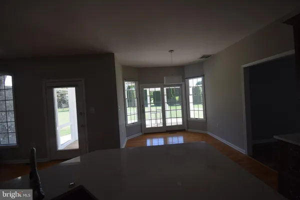 a view of an empty room with large windows