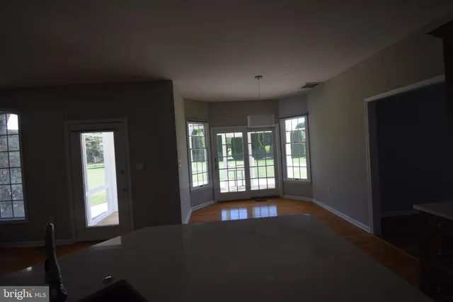 a view of an empty room with large windows