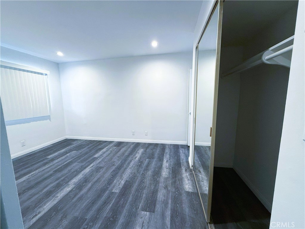 525 Fischer Street, Unit 1 Glendale, CA 91205 - Photo 13 of 25 an empty room with wooden floor and windows