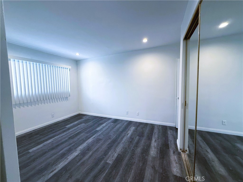 525 Fischer Street, Unit 1 Glendale, CA 91205 - Photo 14 of 25 an empty room with wooden floor and windows