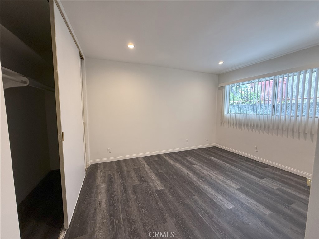 525 Fischer Street, Unit 1 Glendale, CA 91205 - Photo 17 of 25 an empty room with wooden floor and windows