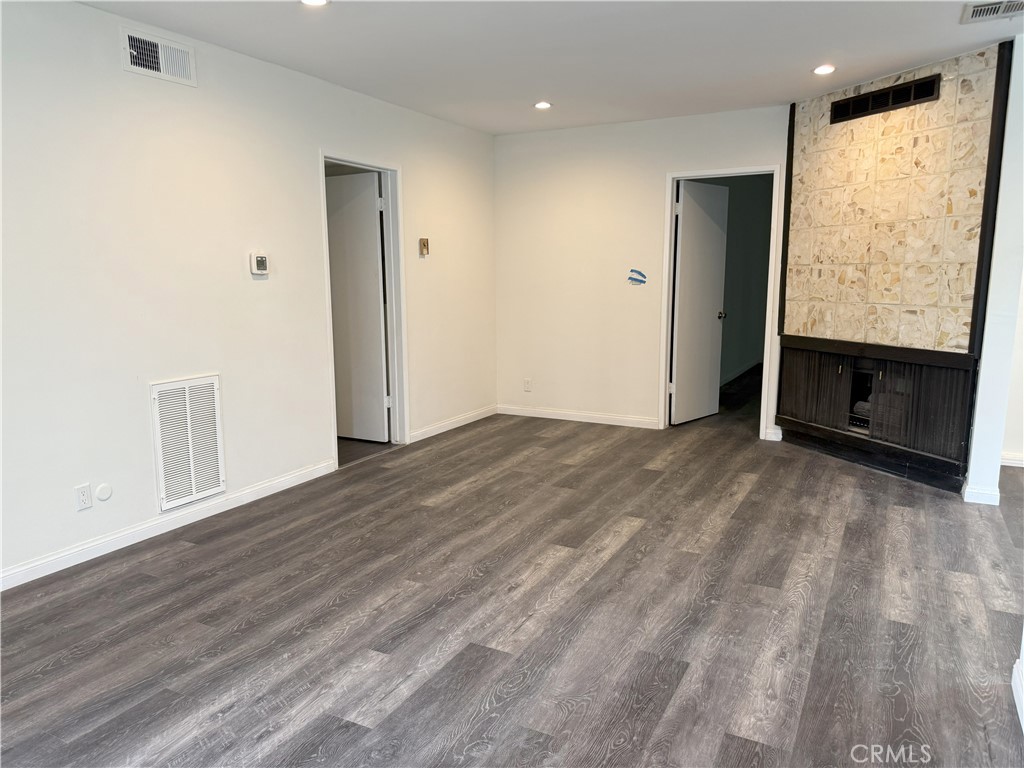 525 Fischer Street, Unit 1 Glendale, CA 91205 - Photo 2 of 25 an empty room with wooden floor closet and windows