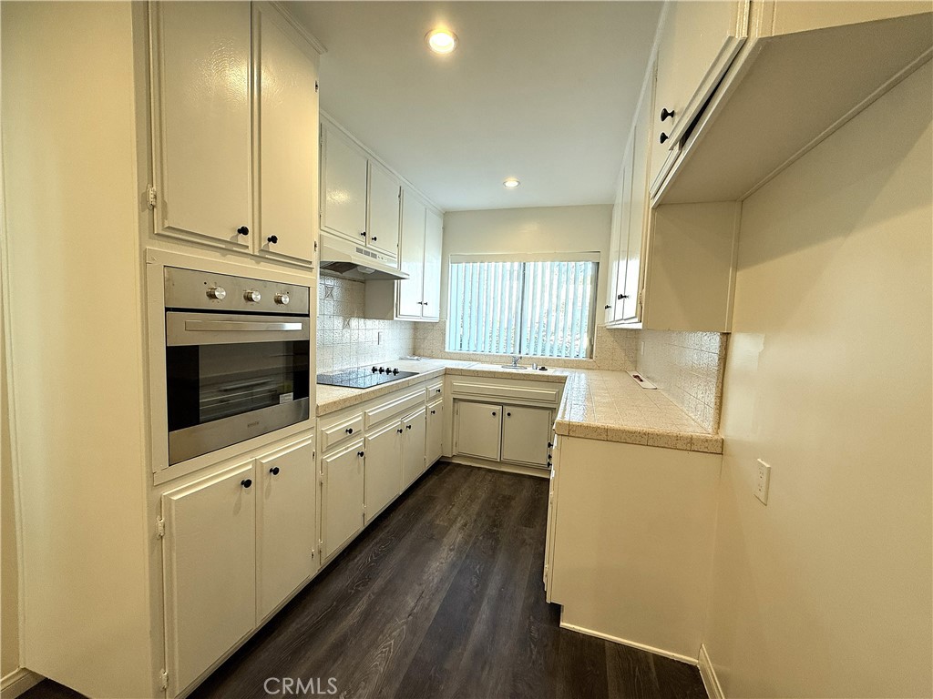 525 Fischer Street, Unit 1 Glendale, CA 91205 - Photo 7 of 25 a kitchen with a refrigerator sink and cabinets