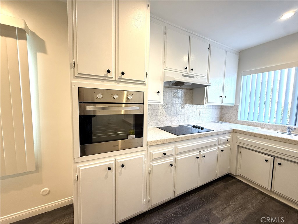 525 Fischer Street, Unit 1 Glendale, CA 91205 - Photo 8 of 25 a kitchen with granite countertop white cabinets and white appliances