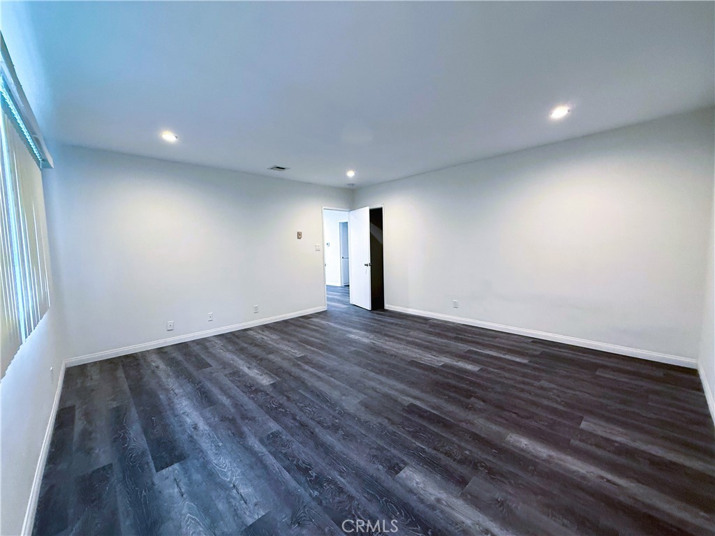 525 Fischer Street, Unit 1 Glendale, CA 91205 - Photo 9 of 25 a view of an empty room with wooden floor and a window