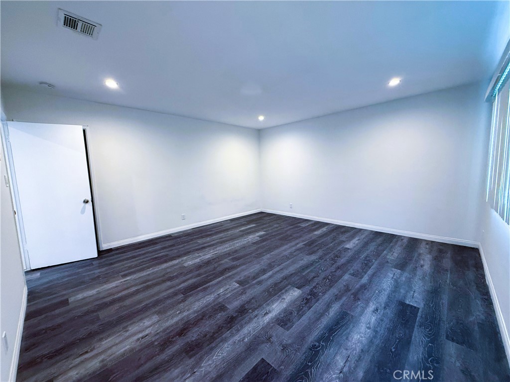 525 Fischer Street, Unit 1 Glendale, CA 91205 - Photo 10 of 25 an empty room with wooden floor and window