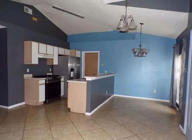 a kitchen with a refrigerator a stove top oven a sink and dishwasher