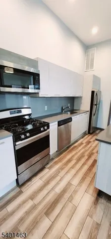 a kitchen with granite countertop a stove and a sink