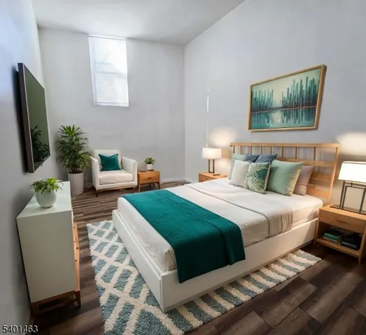 a bedroom with furniture and a flat screen tv