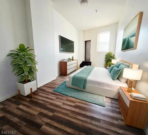 a living room with furniture potted plant and a flat screen tv