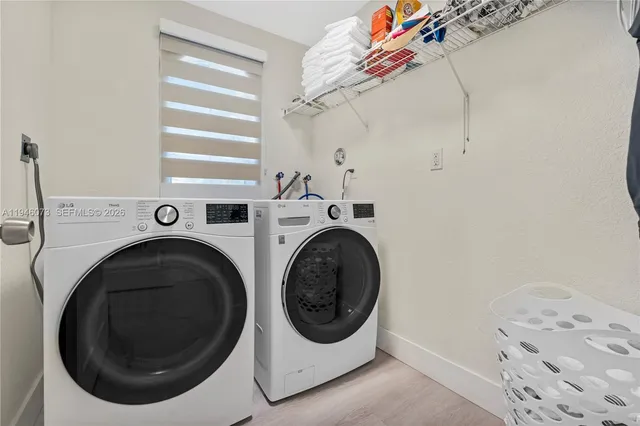 a bedroom with a bed wooden floor and window
