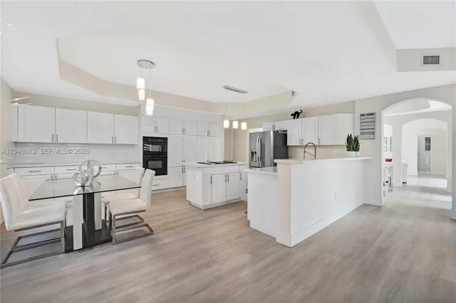 a living room with furniture and a ceiling fan