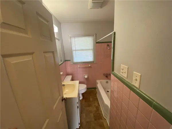 a bathroom with a sink a toilet and mirror
