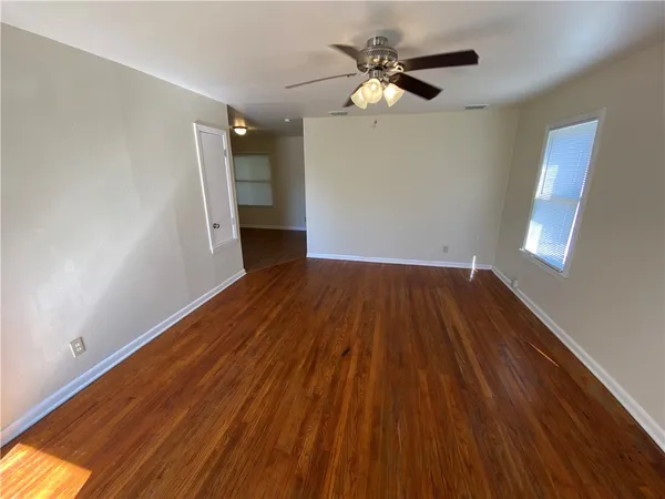wooden floor in an empty room with a window