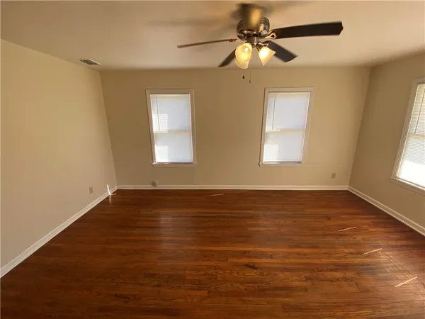 wooden floor in an empty room with a window