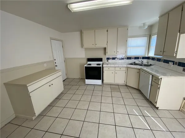 a kitchen with a stove a sink and a refrigerator